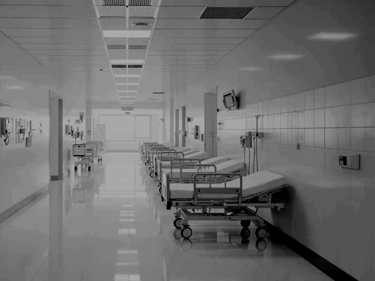 Hospital ward corridor lined with beds